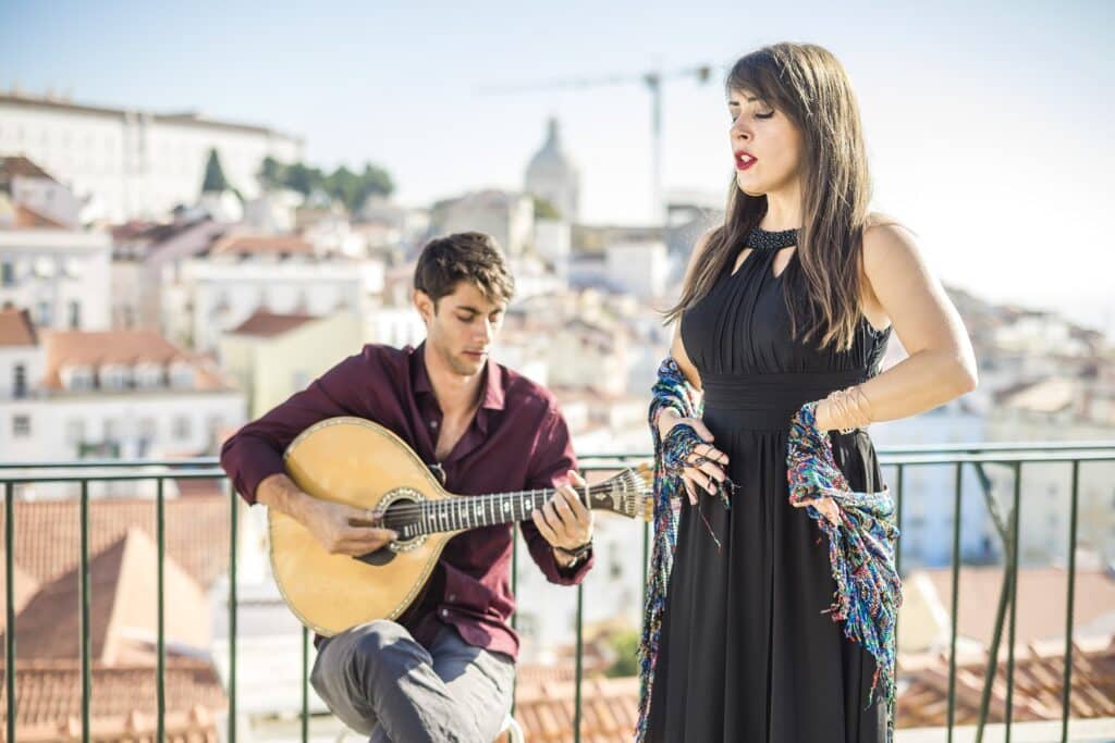 Beautiful fado singer performing with handsome portuguese guitarist player, Portugal